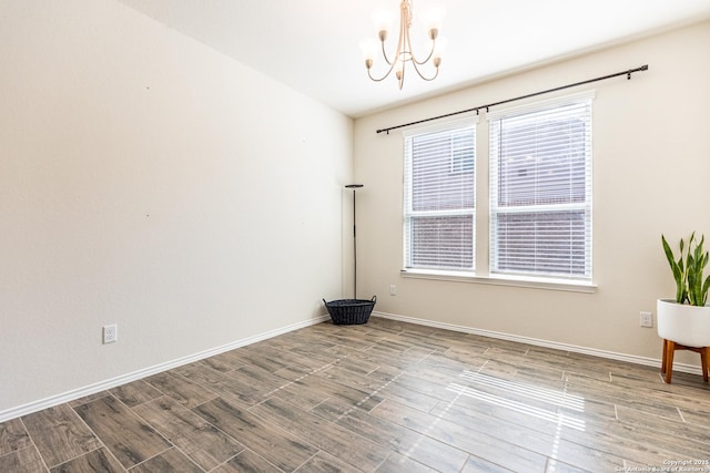 7421 Cimarron Lk, Boerne, TX 78015 - unfurnished room with a chandelier, wood finished floors, and baseboards