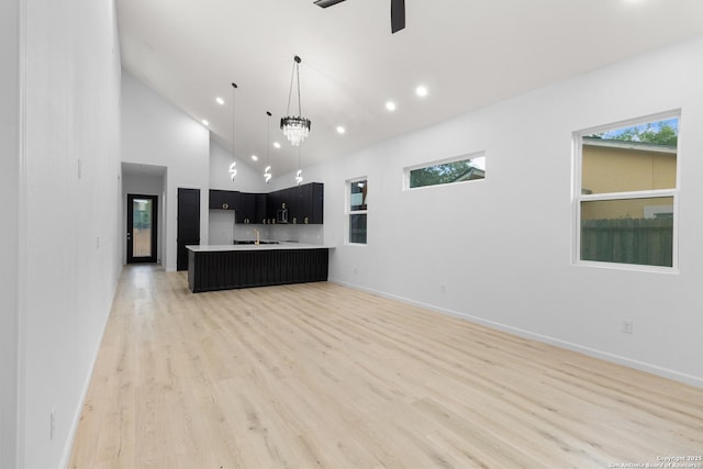 1422 Sherman, San Antonio, TX 78202 - unfurnished living room with recessed lighting, light wood-type flooring, baseboards, high vaulted ceiling, and a ceiling fan