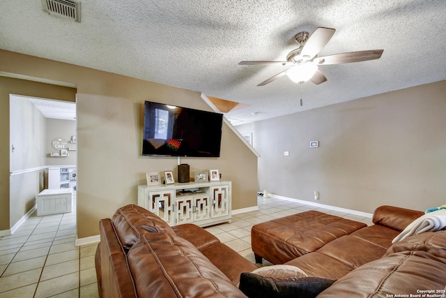 9311 Bowen Dr, San Antonio, TX 78250 - living room featuring light tile patterned floors, a ceiling fan, a textured ceiling, and baseboards
