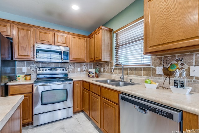 12707 Avens Arbor, San Antonio, TX 78253 - kitchen featuring appliances with stainless steel finishes, a sink, light countertops, and backsplash