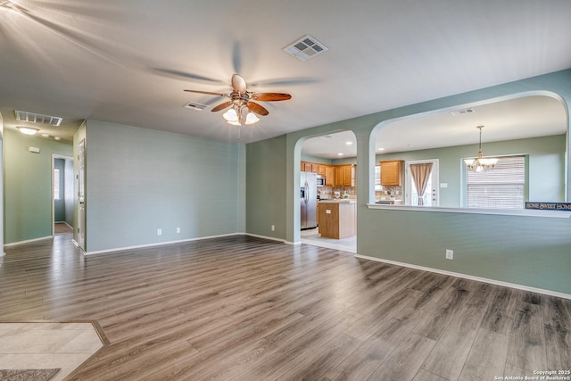 12707 Avens Arbor, San Antonio, TX 78253 - unfurnished living room featuring wood finished floors, ceiling fan, and arched walkways