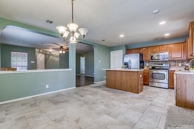 12707 Avens Arbor, San Antonio, TX 78253 - kitchen with appliances with stainless steel finishes, a kitchen island, light countertops, a sink, and a ceiling fan