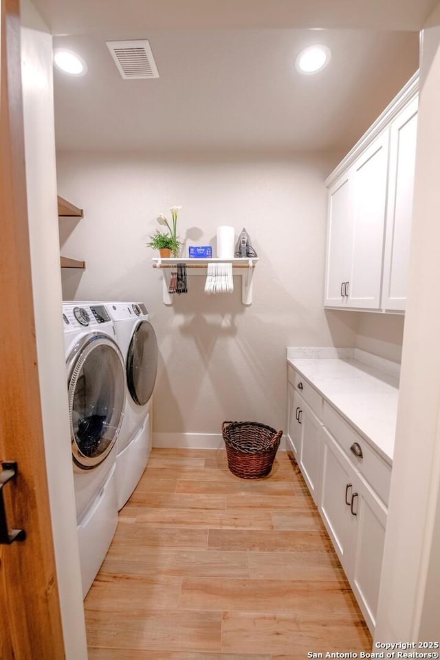 113 Bayberry Ct, La Vernia, TX 78121 - laundry area with washer and clothes dryer, cabinet space, recessed lighting, baseboards, and light wood-type flooring