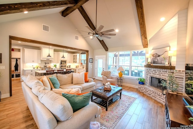 113 Bayberry Ct, La Vernia, TX 78121 - living room featuring high vaulted ceiling, beamed ceiling, baseboards, light wood finished floors, and ceiling fan
