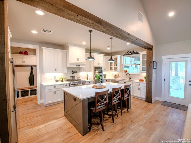 113 Bayberry Ct, La Vernia, TX 78121 - kitchen featuring a sink, appliances with stainless steel finishes, a kitchen bar, tasteful backsplash, and light countertops
