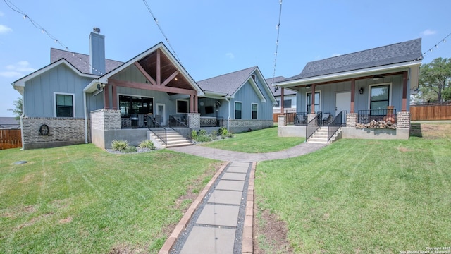 113 Bayberry Ct, La Vernia, TX 78121 - bungalow-style house featuring a porch, board and batten siding, a chimney, and brick siding