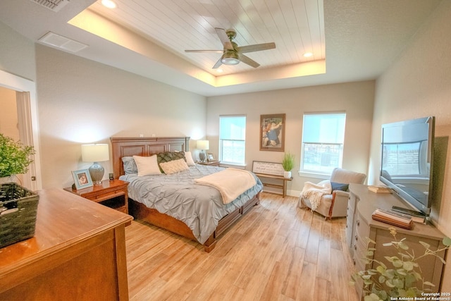 113 Bayberry Ct, La Vernia, TX 78121 - bedroom featuring a tray ceiling, light wood finished floors, ceiling fan, and recessed lighting