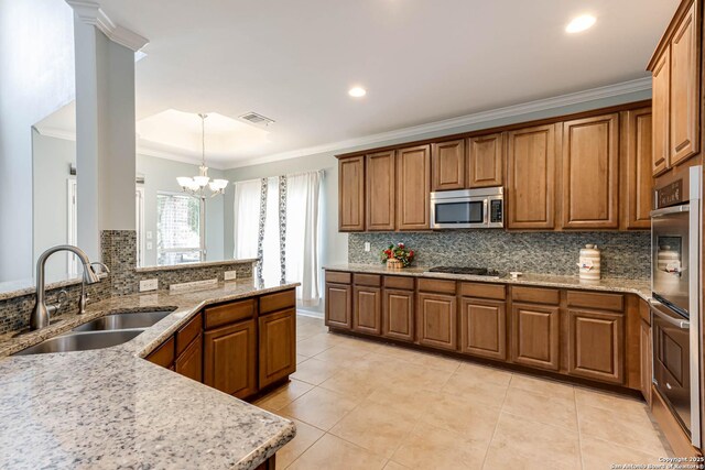 3319 Brooktree Ct, San Antonio, TX 78261 - kitchen with a sink, stainless steel appliances, brown cabinets, crown molding, and recessed lighting