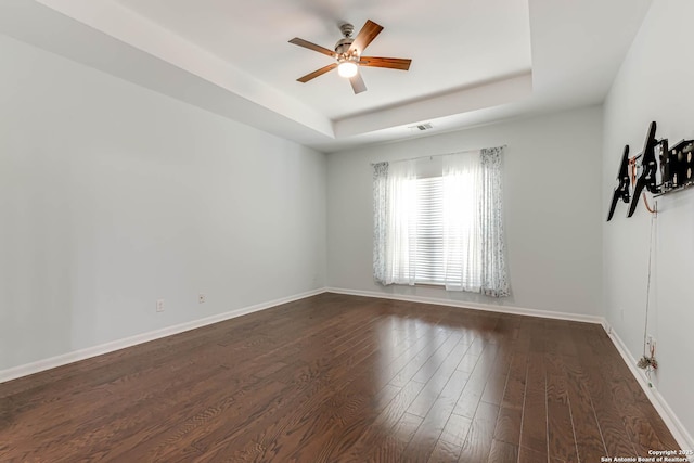 3319 Brooktree Ct, San Antonio, TX 78261 - empty room featuring a raised ceiling, ceiling fan, dark wood-type flooring, and baseboards