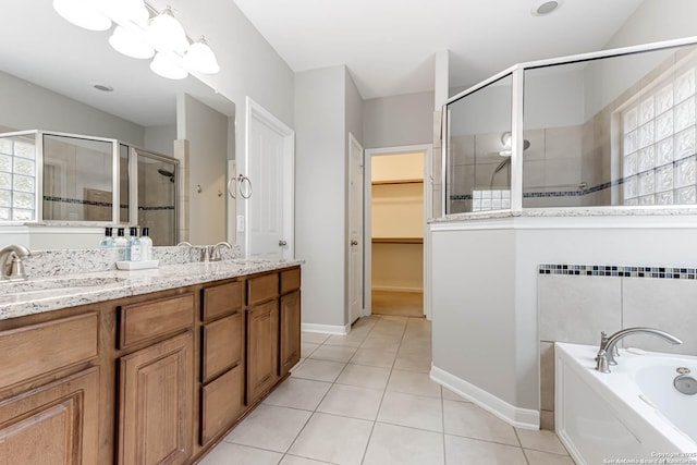 3319 Brooktree Ct, San Antonio, TX 78261 - full bath featuring a shower stall, double vanity, tile patterned floors, a spacious closet, and a garden tub