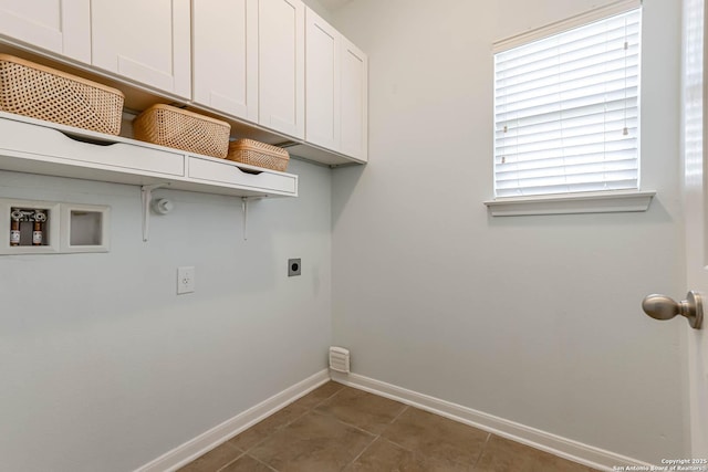 3319 Brooktree Ct, San Antonio, TX 78261 - washroom with electric dryer hookup, baseboards, tile patterned flooring, washer hookup, and cabinet space