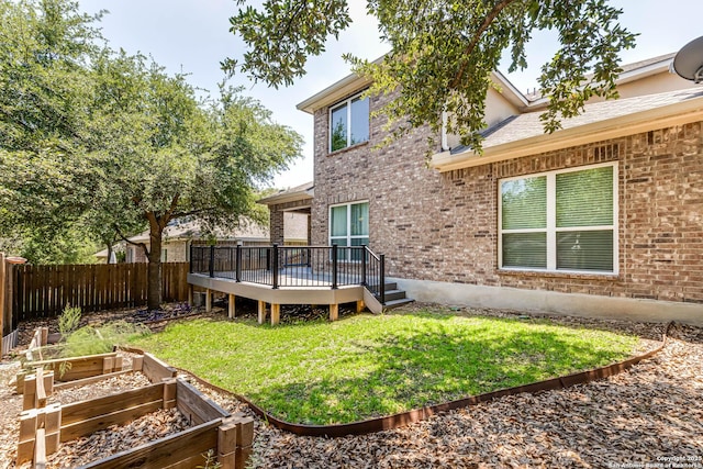 3319 Brooktree Ct, San Antonio, TX 78261 - rear view of house with a vegetable garden, a deck, and brick siding