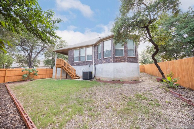 10772 Texas Star, Helotes, TX 78023 - rear view of house with brick siding, stairs, and central AC