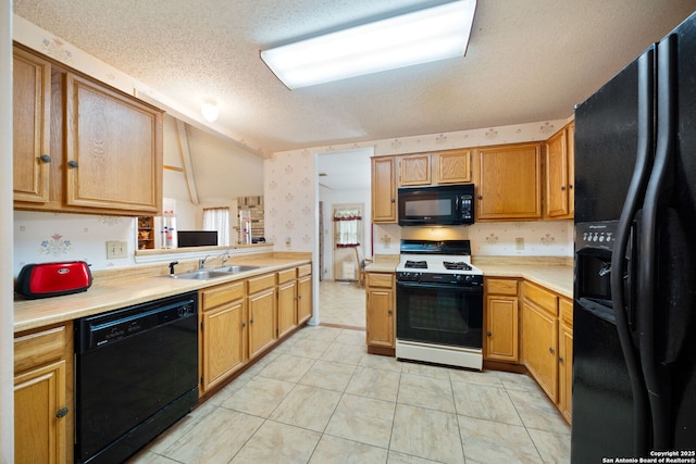 11334 Bald Mountain Dr, San Antonio, TX 78245 - kitchen with black appliances, a sink, light countertops, a textured ceiling, and wallpapered walls