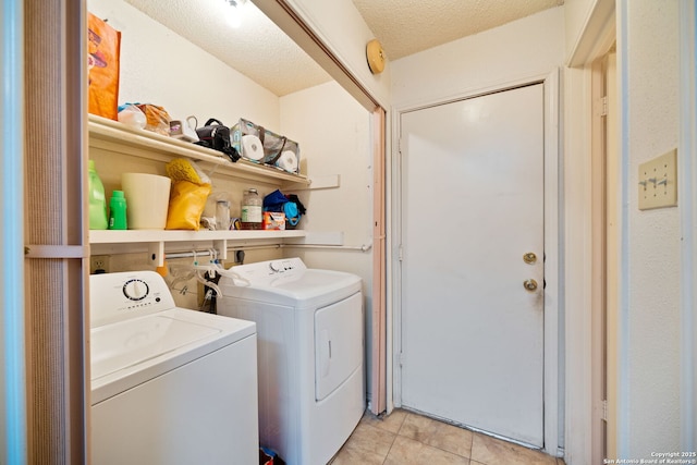 11334 Bald Mountain Dr, San Antonio, TX 78245 - washroom with independent washer and dryer, light tile patterned flooring, and a textured ceiling