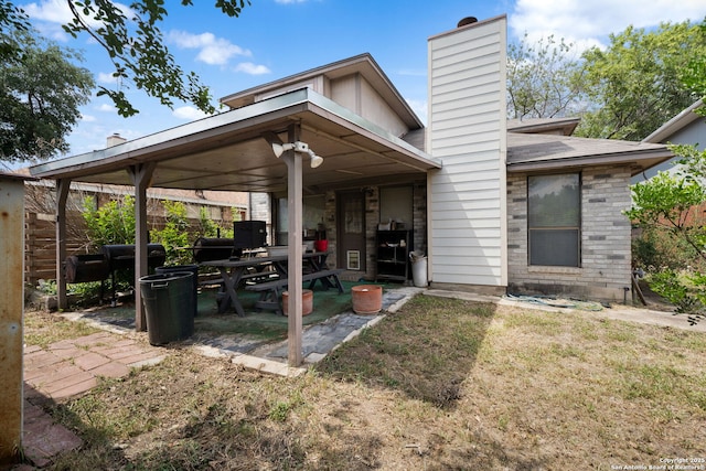 11334 Bald Mountain Dr, San Antonio, TX 78245 - rear view of house featuring a chimney and a patio area