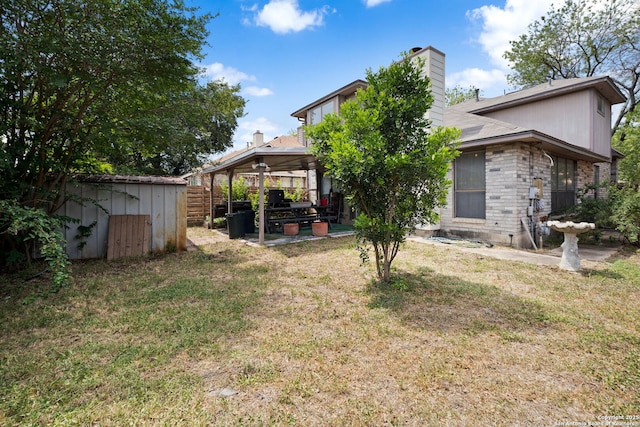 11334 Bald Mountain Dr, San Antonio, TX 78245 - back of property with a patio area, a chimney, and a gazebo