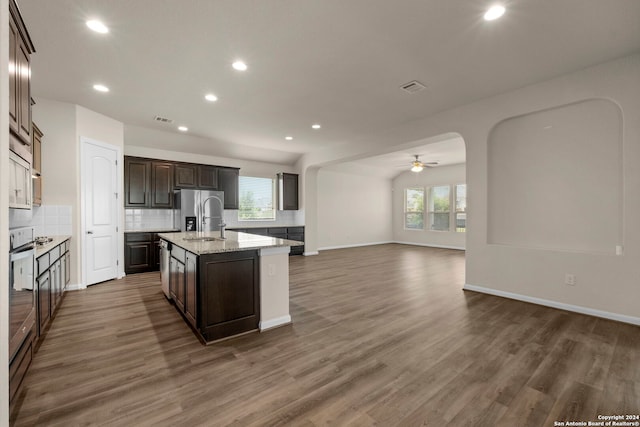 6595 Mason Vly, Schertz, TX 78108 - kitchen with a ceiling fan, a sink, a kitchen island with sink, backsplash, and open floor plan