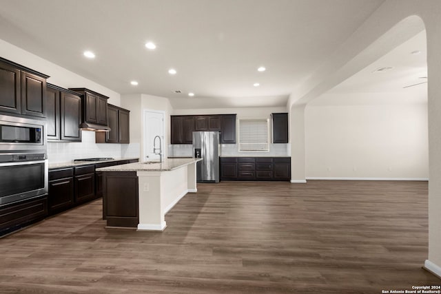 6595 Mason Vly, Schertz, TX 78108 - kitchen featuring appliances with stainless steel finishes, decorative backsplash, a sink, dark wood-style flooring, and recessed lighting