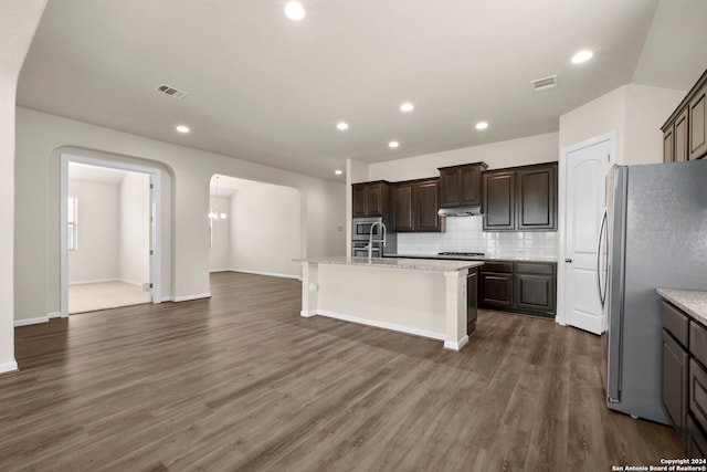 6595 Mason Vly, Schertz, TX 78108 - kitchen with stainless steel appliances, arched walkways, decorative backsplash, recessed lighting, and an island with sink
