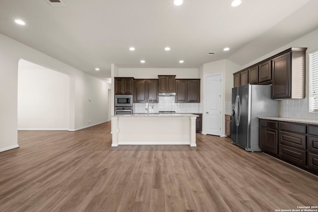 6595 Mason Vly, Schertz, TX 78108 - kitchen with stainless steel appliances, decorative backsplash, recessed lighting, dark brown cabinets, and a kitchen island with sink