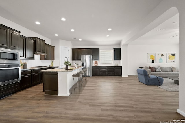 6595 Mason Vly, Schertz, TX 78108 - kitchen with appliances with stainless steel finishes, open floor plan, backsplash, wood finished floors, and recessed lighting