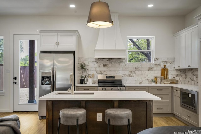 1947 W French Pl, San Antonio, TX 78201 - kitchen with appliances with stainless steel finishes, light wood-type flooring, decorative backsplash, and recessed lighting