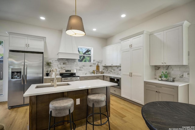 1947 W French Pl, San Antonio, TX 78201 - kitchen featuring stainless steel appliances, a sink, custom range hood, light wood-style floors, and recessed lighting