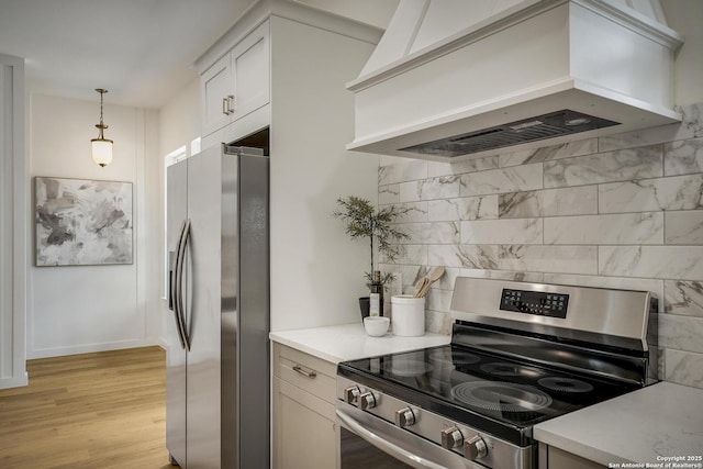 1947 W French Pl, San Antonio, TX 78201 - kitchen featuring stainless steel appliances, custom range hood, tasteful backsplash, light wood-type flooring, and hanging light fixtures