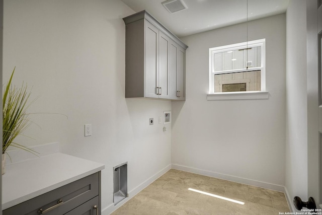 1947 W French Pl, San Antonio, TX 78201 - laundry room with cabinet space, electric dryer hookup, hookup for a washing machine, and baseboards