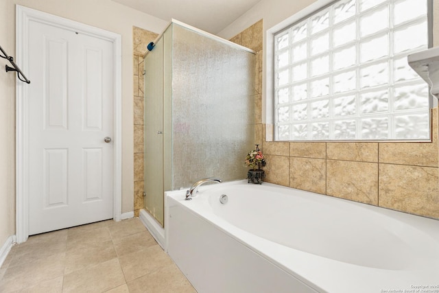 8607 Lahemaa, San Antonio, TX 78251 - bathroom featuring a bath, a shower stall, tile patterned flooring, and baseboards