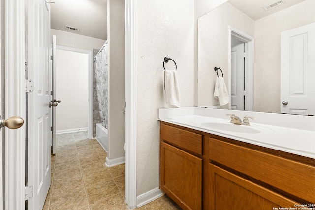 8607 Lahemaa, San Antonio, TX 78251 - full bath with vanity, tile patterned flooring, baseboards, and shower / bath combination with curtain