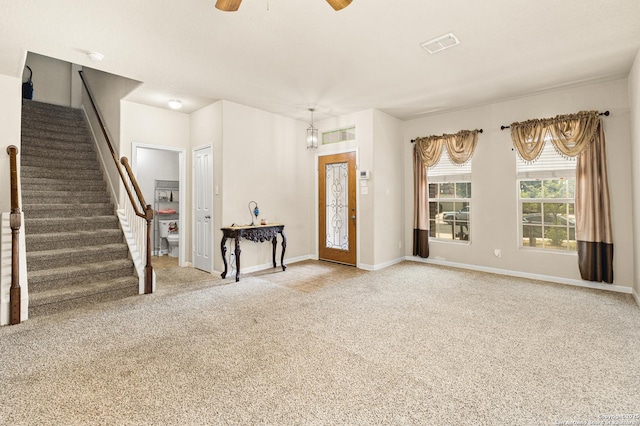 8607 Lahemaa, San Antonio, TX 78251 - unfurnished living room with carpet flooring, stairs, ceiling fan, and baseboards