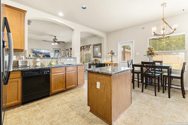 8607 Lahemaa, San Antonio, TX 78251 - kitchen featuring dishwasher, brown cabinets, a sink, dark stone countertops, and a chandelier