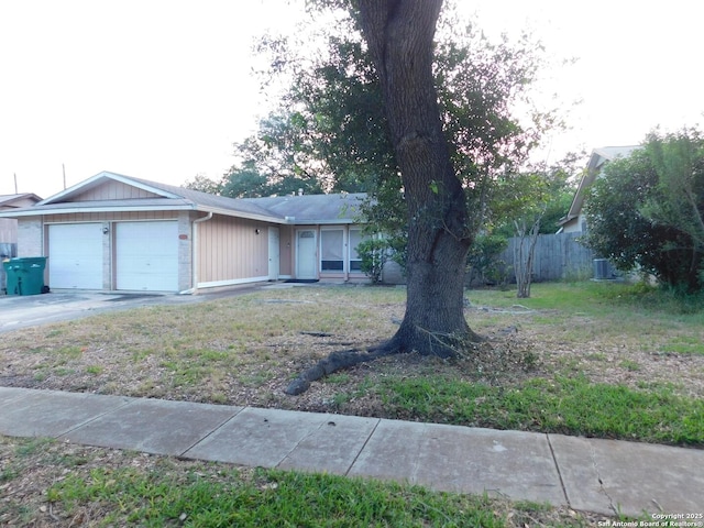 10223 Flatland Trl, Converse, TX 78109 - single story home with an attached garage, concrete driveway, and central air condition unit