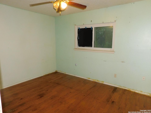 10223 Flatland Trl, Converse, TX 78109 - spare room with a ceiling fan, wood finished floors, and baseboards