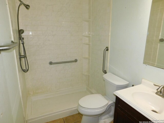 10223 Flatland Trl, Converse, TX 78109 - bathroom with a shower stall, vanity, toilet, and tile patterned floors