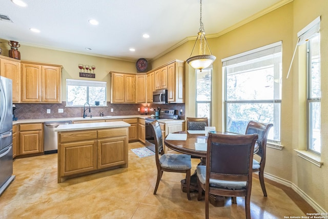 448 Western, Bandera, TX 78003 - kitchen featuring stainless steel appliances, decorative backsplash, light countertops, a sink, and ornamental molding