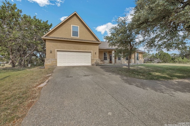 448 Western, Bandera, TX 78003 - traditional-style house with a front yard, driveway, stone siding, and an attached garage