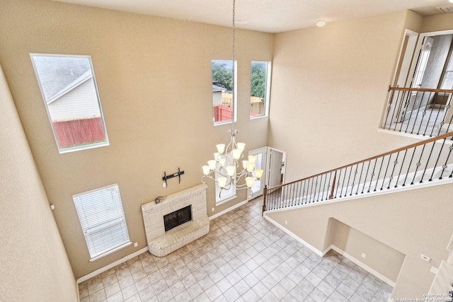 5514 Waldon Walk, San Antonio, TX 78261 - unfurnished living room featuring a chandelier, plenty of natural light, and a brick fireplace