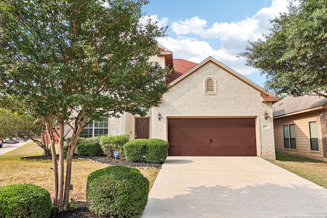 5514 Waldon Walk, San Antonio, TX 78261 - view of front of house with an attached garage, concrete driveway, a front lawn, and brick siding