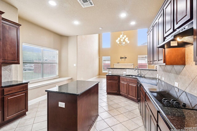 5514 Waldon Walk, San Antonio, TX 78261 - kitchen with a sink, black electric stovetop, under cabinet range hood, tasteful backsplash, and recessed lighting