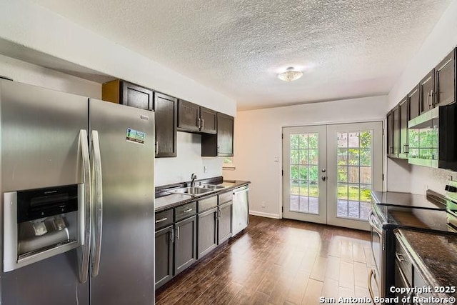 6862 Maple Spgs Unit 6862, San Antonio, TX 78249 - kitchen featuring appliances with stainless steel finishes, a sink, french doors, dark brown cabinets, and a textured ceiling