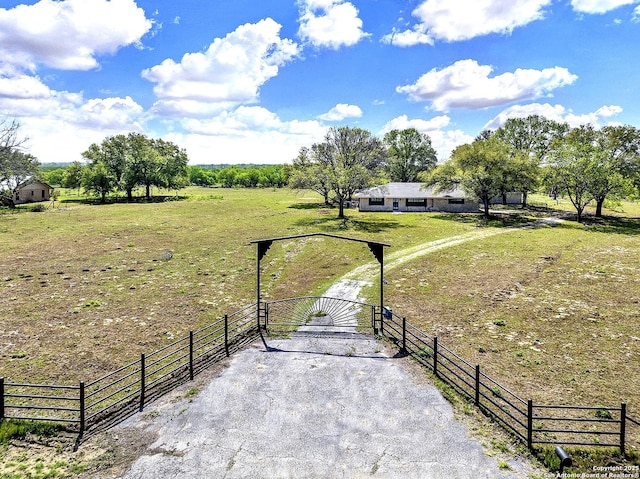 1212 County Road 337, La Vernia, TX 78121 - view of yard with a gate, a view of rural / pastoral area, and asphalt driveway