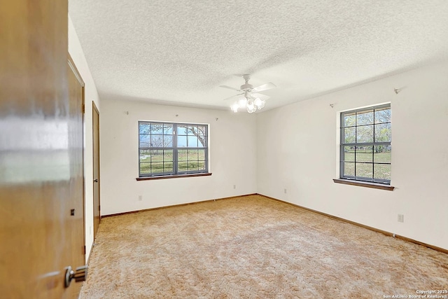 1212 County Road 337, La Vernia, TX 78121 - carpeted empty room featuring plenty of natural light, ceiling fan, a textured ceiling, and baseboards