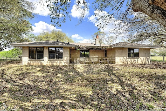 1212 County Road 337, La Vernia, TX 78121 - view of front facade featuring brick siding and a chimney