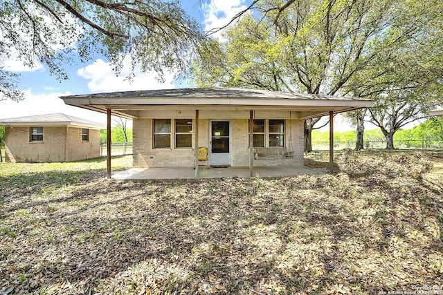 1212 County Road 337, La Vernia, TX 78121 - back of property featuring a patio area and brick siding