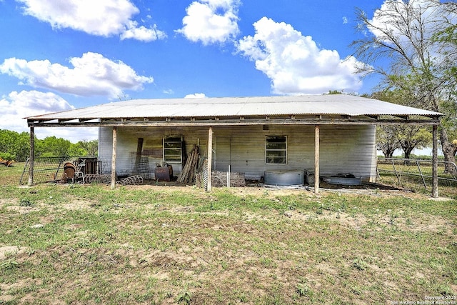 1212 County Road 337, La Vernia, TX 78121 - back of property with an exterior structure, an outdoor structure, and metal roof