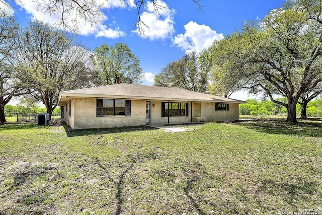 1212 County Road 337, La Vernia, TX 78121 - view of front of property with a front lawn, cooling unit, and brick siding