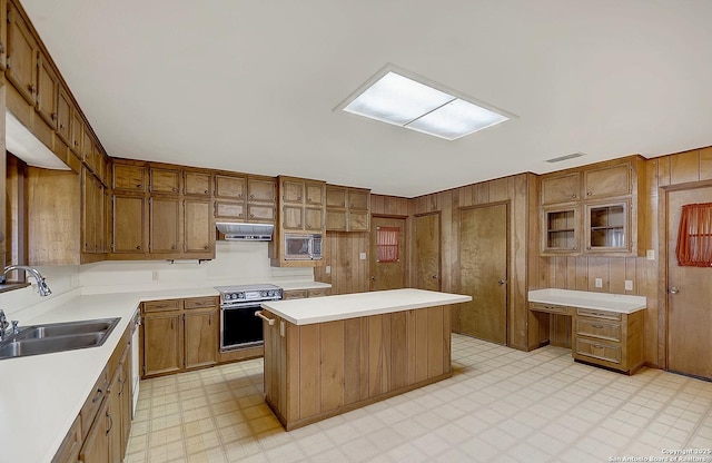 1212 County Road 337, La Vernia, TX 78121 - kitchen with a sink, light floors, electric stove, stainless steel microwave, and brown cabinets